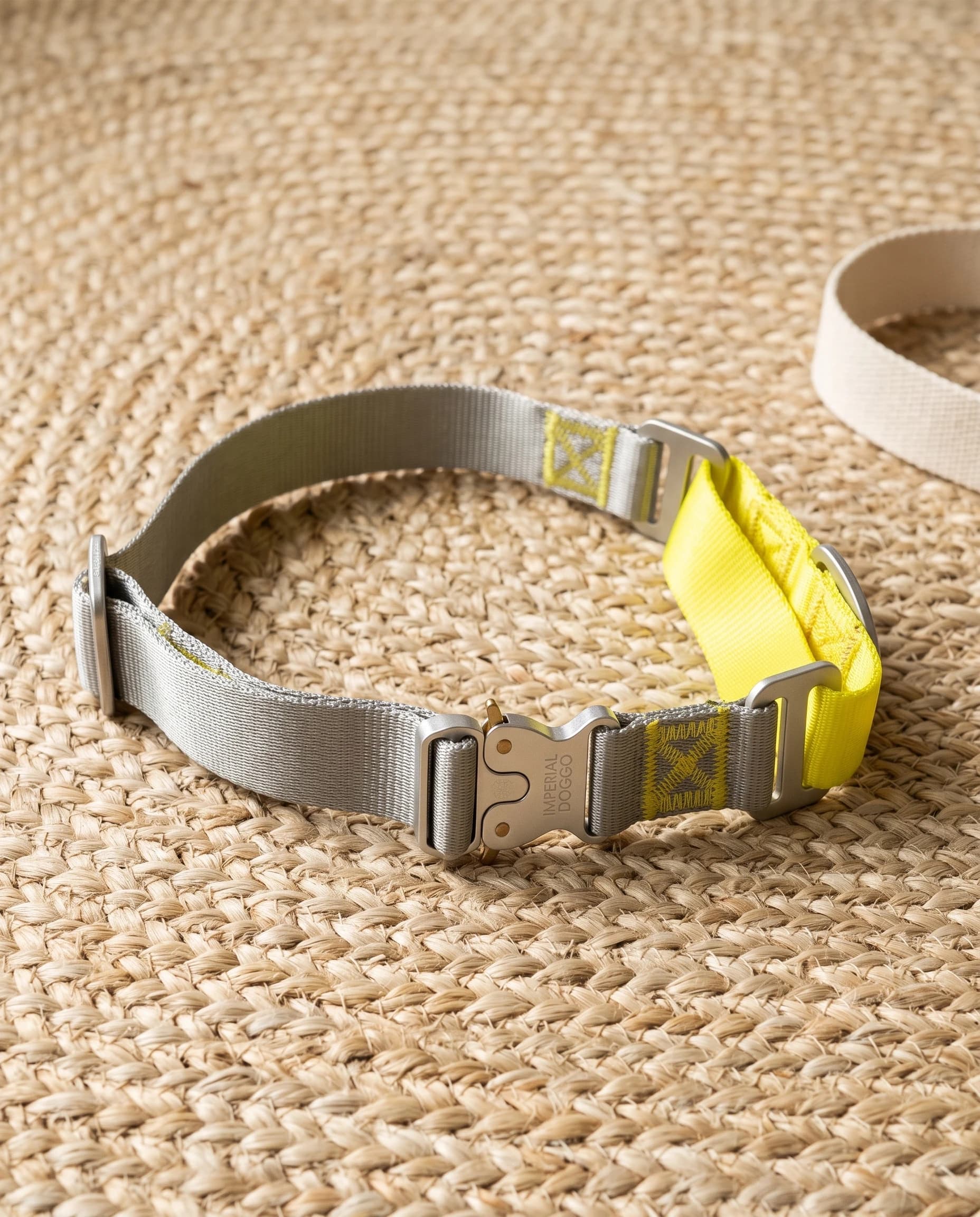 Field Collar in yellow on a round jute mat, silver-grey webbing with the neon-yellow trim and aluminium cobra buckle