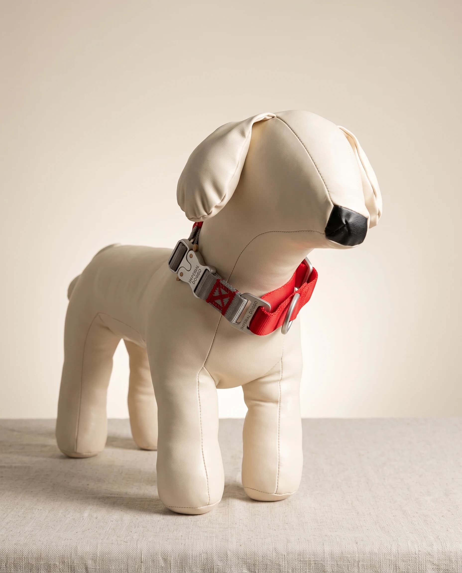 The red Field Collar fastened on a studio dog form, showing how it sits at the neck