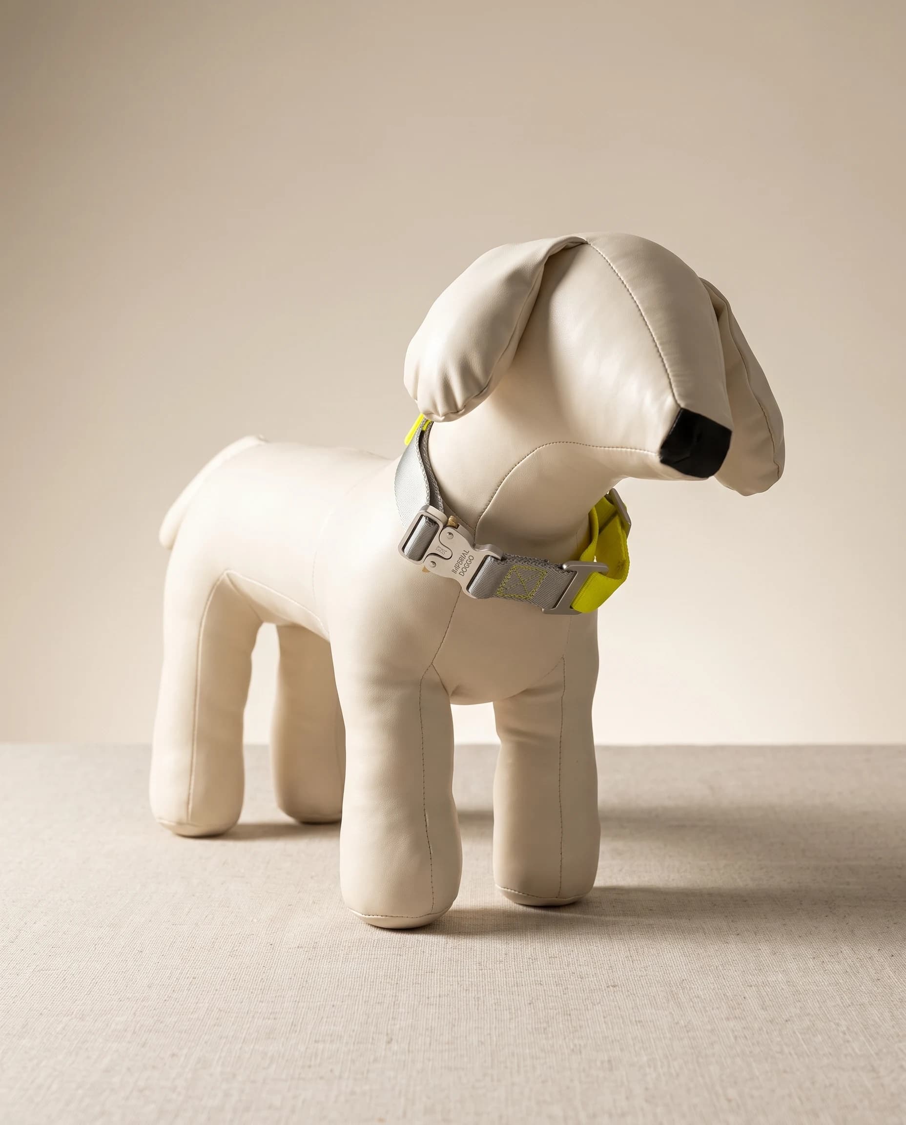 The yellow Field Collar fastened on a studio dog form, showing how it sits at the neck