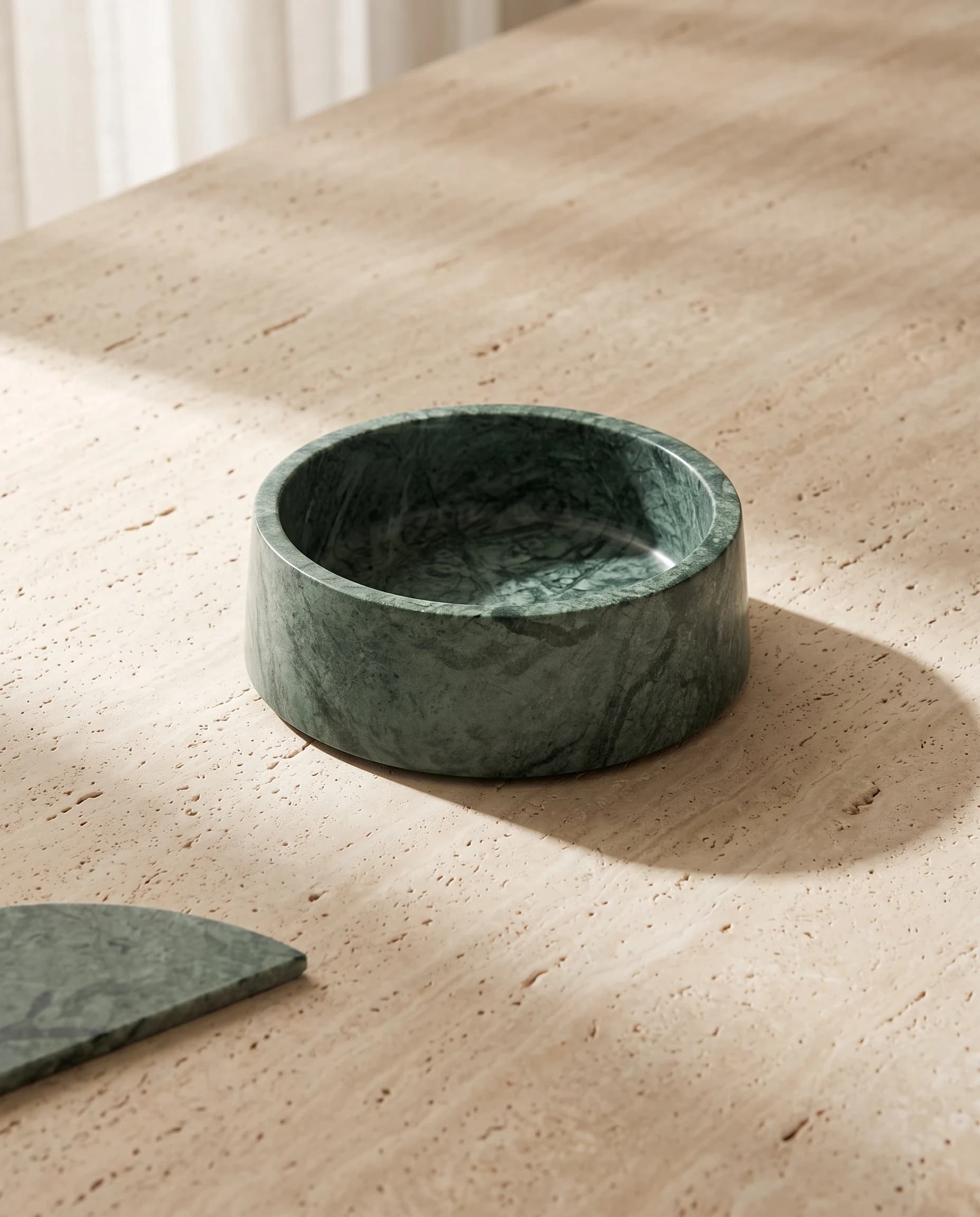 The Verde Guatemala bowl at an angle, pale veining through the deep green stone
